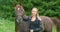 Young woman caressing her arabian horse standing in the field