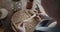 Young woman carpenter examines handmade wooden spoon close-up