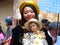 Young woman carries baby Jesus doll on Christmas parade