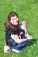 Young woman carrying baby in rucksack in park
