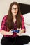 Young woman in casual playing videogame