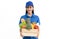 Young woman caucasian grocery delivery courier man in blue uniform with grocery wooden box with fresh fruit and vegetable.