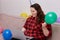 A young woman celebrates her birthday at home online with a laptop in her hands.