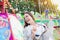 Young woman on chain swing ride, amusement park