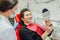 Young woman checking their teeth at mirror after dental treatment - People bodycare and stomatology concept for healthy