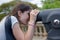 Young woman checking view of Barcelona with binoculars