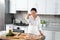 Young woman chef adds toppings to pizza. The chef throws mushrooms on the pizza from above. Cooking vegan pizza