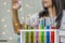 Young woman chemist,Work laboratory,Check test kit in hand with test samples, work with colorful liquid chemicals,In glass tubes