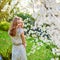 Young woman in cherry blossom garden