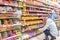 a young woman with a child chooses sweets in the confectionery department of the store.