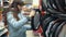 A young woman chooses a cover for steering the car.