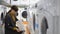 A young woman chooses a dryer machine in a home appliance store