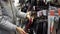 A young woman chooses a non-stick frying pan in the store.