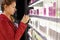 Young woman chooses perfume in shop.