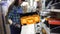 A young woman chooses a plastic tool box in the store.