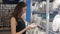 Young woman chooses plates in shop cookware, dish choosing by elegant girl in supermarket