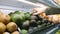 Young Woman Choosing Avocados in Grocery Store. Vegan Zero Waste Girl Buying Fruits and Veggies in Organic Supermarket. 4K.