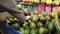 Young Woman Choosing Avocados in Grocery Store. Vegan Zero Waste Girl Buying Fruits and Veggies in Organic Supermarket. 4K.