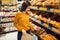 Young woman choosing bread in grocery store