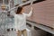 Young woman choosing fire resistant drywall sheets in hardware store