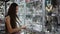 Young woman is choosing jewelry in the shop