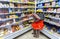 Young woman choosing salmon fish at shopping in chain supermarket