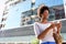 Young woman in the city with cell phone