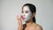 Young woman clay face mask peeling natural with purifying mask on her face