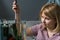 Young woman cleaning aquarium with beta fish at home.