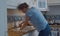 Young woman cleaning a blockage in a kitchen sink