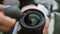 Young woman cleaning camera lens