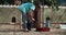 Young woman cleaning chicken coop on her rustic house from poops at sunny day