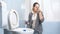 Young woman cleaning cleaning toilet feeling bad smell and closing nose with clothespin