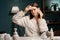 Young woman cleaning face with white pads and toner looking at camera. Girl removing makeup with cosmetic cotton pad