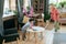 Young woman cleaning floor while her son wiping table with sanitizer