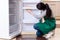 The young woman cleaning fridge in hygiene concept