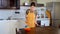 Young woman cleaning the furniture in the kitchen