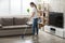 Young Woman Cleaning The Hardwood Floor