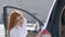 Young woman cleaning her new car after wash with microfiber cloth.