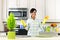 Young woman cleaning kitchen