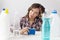 Young woman and cleaning products