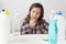Young woman and cleaning products