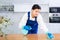 Young woman, cleaning service worker, wiping dust on furniture