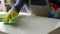 Young woman cleaning the table close-up