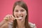 Young Woman Cleaning Tongue Using Toothbrush