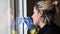 Young woman cleaning a window