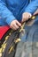 Young woman cleans wiper blades and windshield from fallen leaves