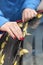 Young woman cleans wiper blades and windshield from yellow leaves