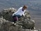 Young woman on cliff edge