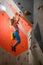 Young Woman Climber Bouldering in the Climbing Gym. Extreme Sport and Indoor Climbing Concept
